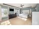 Spacious main bedroom showcasing a tray ceiling, large windows, and a ceiling fan at 4001 Brook Valley Run, Monroe, NC 28110