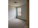 Comfortable bedroom with neutral walls, carpet, and a window offering natural light and outdoor views at 436 Phifer Rd, Kings Mountain, NC 28086