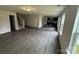 Spacious living area featuring wood-look floors, a staircase, and a kitchen with black cabinetry at 436 Phifer Rd, Kings Mountain, NC 28086