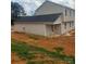 The back of the home features a covered porch and second-story windows overlooking a large, grassy backyard at 438 Phifer Rd, Kings Mountain, NC 28086