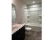Clean bathroom featuring a shower-tub combo with shelves, a white toilet, and a vanity sink at 438 Phifer Rd, Kings Mountain, NC 28086