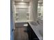 Bright bathroom features a tub-shower combo, double sinks, and dark wood cabinets at 438 Phifer Rd, Kings Mountain, NC 28086