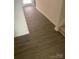 Clean and modern hallway with wood-look flooring and freshly painted white trim and walls at 438 Phifer Rd, Kings Mountain, NC 28086