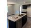 Elegant kitchen with black cabinets, granite countertops, stainless steel appliances, and stylish lighting at 438 Phifer Rd, Kings Mountain, NC 28086