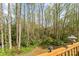 The backyard features a beautiful wooded area with a deck and lantern at 4896 Birch Cir, Hickory, NC 28602