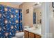 Cozy bathroom with colorful shower curtain and older-style vanity at 4896 Birch Cir, Hickory, NC 28602