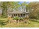 Charming ranch-style home featuring a cozy front porch and beautiful landscaping with a tranquil pond at 4896 Birch Cir, Hickory, NC 28602