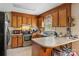 Functional kitchen boasting wood cabinetry, white countertops, and stainless steel appliances at 4896 Birch Cir, Hickory, NC 28602