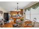 Cozy kitchen featuring classic oak cabinetry, a breakfast bar, and an adjacent dining area with a glass-top table at 4896 Birch Cir, Hickory, NC 28602
