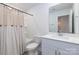 Bright bathroom with a shower over tub combination, white vanity, and ample counter space at 504 Cranford Dr, Pineville, NC 28134