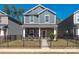 Charming two-story home features a stone facade, black fence, and landscaped front yard at 504 Cranford Dr, Pineville, NC 28134