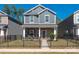 Charming two-story home featuring a stone facade, inviting front porch, fenced front yard, and meticulous landscaping at 504 Cranford Dr, Pineville, NC 28134