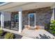 Welcoming front porch detailed with stacked stone, seating, and charming fall decor for a cozy entrance at 504 Cranford Dr, Pineville, NC 28134
