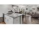 Open-concept kitchen flows into dining and living areas, featuring granite countertops and hardwood floors at 504 Cranford Dr, Pineville, NC 28134