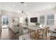 Bright and open living area with hardwood floors, modern furniture, and a seamless flow to the dining space at 504 Cranford Dr, Pineville, NC 28134