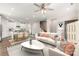 Open-concept living area flowing into the kitchen, featuring modern furnishings, hardwood floors, and ample natural light at 504 Cranford Dr, Pineville, NC 28134