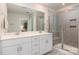 Bright bathroom featuring double vanity, quartz counters, framed mirrors, and a tiled walk-in shower at 504 Cranford Dr, Pineville, NC 28134