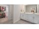 Main bathroom featuring double vanity, walk-in closet, and easy access to a walk-in closet at 504 Cranford Dr, Pineville, NC 28134