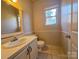Cozy bathroom with vanity, white fixtures, and tile floors at 5416 River Falls Dr, Charlotte, NC 28215