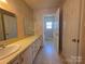 Bathroom featuring a double sink and ample vanity space at 5416 River Falls Dr, Charlotte, NC 28215