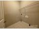 Walk in closet with wire rack shelving, tiled floor and textured walls at 5416 River Falls Dr, Charlotte, NC 28215