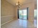 A bright dining room with tile floors and sliding glass doors to the backyard at 5416 River Falls Dr, Charlotte, NC 28215