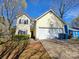 Charming two-story home with a two-car garage, classic design, and manicured front yard at 5416 River Falls Dr, Charlotte, NC 28215