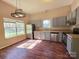 Bright kitchen featuring stainless steel appliances, grey cabinetry, and hardwood floors at 5416 River Falls Dr, Charlotte, NC 28215