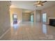 Open living room with tile flooring, ceiling fan, and fireplace at 5416 River Falls Dr, Charlotte, NC 28215