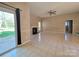 Open living room with tiled floors, a fireplace, and a sliding glass door at 5416 River Falls Dr, Charlotte, NC 28215