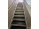 View looking up a black and white painted staircase at 5416 River Falls Dr, Charlotte, NC 28215