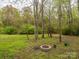 Picture of backyard featuring trees, grass, outdoor seating and fire pit perfect for gathering at 5601 Indian Brook Dr, Matthews, NC 28104