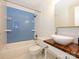 Updated bathroom with blue tiled walls in shower, modern sink, and fixtures at 5601 Indian Brook Dr, Matthews, NC 28104