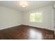 Bright bedroom with hardwood floors and a large window that bathes the room in natural light at 5601 Indian Brook Dr, Matthews, NC 28104