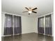Neutral bedroom with ceiling fan, tiled floors and natural light from two windows with curtains at 5601 Indian Brook Dr, Matthews, NC 28104