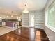 Open dining area with hardwood floors, built-in bookshelves, and view to the kitchen at 5601 Indian Brook Dr, Matthews, NC 28104