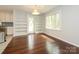 Dining area with hardwood floors, large window, and built-in bookshelves at 5601 Indian Brook Dr, Matthews, NC 28104