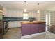 Modern kitchen with stainless steel appliances, a wooden island, and stylish backsplash at 5601 Indian Brook Dr, Matthews, NC 28104