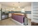 Well-lit kitchen featuring stainless steel appliances, custom island, and tile backsplash at 5601 Indian Brook Dr, Matthews, NC 28104
