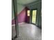 Unique room features a painted accent wall and patterned tile flooring, with a door leading to an outdoor area at 5601 Indian Brook Dr, Matthews, NC 28104