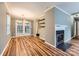 Dining area with fireplace, hardwood floors, and glass doors opening to the outside at 5913 Crape Myrtle Ln, Charlotte, NC 28216