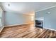 A spacious living room is enhanced with the fireplace and the warm tones of the hardwood floor at 5913 Crape Myrtle Ln, Charlotte, NC 28216