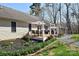 This landscaped backyard features a beautiful deck, perfect for entertaining and enjoying the serene natural surroundings at 623 Roxboro Dr, Mount Gilead, NC 27306