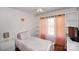 Cozy bedroom with a built-in shelving unit and a decorative butterfly on the wall at 623 Roxboro Dr, Mount Gilead, NC 27306