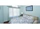 Bright bedroom with large window, light blue walls, and floral bedding at 623 Roxboro Dr, Mount Gilead, NC 27306