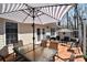 Outdoor deck with umbrella, table and chairs, providing a relaxing and inviting space for outdoor dining and entertaining at 623 Roxboro Dr, Mount Gilead, NC 27306