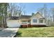 Charming one-story home with a well-manicured lawn, attached garage, and inviting front porch at 623 Roxboro Dr, Mount Gilead, NC 27306