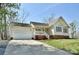 Well-maintained home featuring an attached garage, manicured lawn, and a welcoming front porch at 623 Roxboro Dr, Mount Gilead, NC 27306