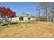 Charming one-story home with a long driveway, green roof, and a beautiful red maple tree in the front yard at 623 Roxboro Dr, Mount Gilead, NC 27306