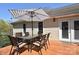 Enjoy outdoor dining on this deck with patio furniture and sunny backyard at 623 Roxboro Dr, Mount Gilead, NC 27306